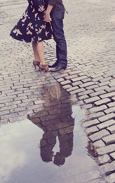Kissing in the rain.